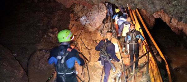 In this undated photo released by Royal Thai Navy on Saturday, July 7, 2018, Thai rescue team members walk inside a cave where 12 boys and their soccer coach have been trapped since June 23, in Mae Sai, Chiang Rai province, northern Thailand In this undated photo released by Royal Thai Navy on Saturday, July 7, 2018, Thai rescue team members walk inside a cave where 12 boys and their soccer coach have been trapped since June 23, in Mae Sai, Chiang Rai province, northern Thailand - Sputnik International