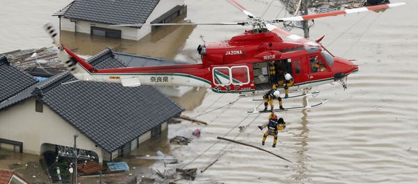 An aerial view shows a local resident being rescued from a submerged house by rescue workers using helicopter at a flooded area in Kurashiki, southern Japan, in this photo taken by Kyodo July 7, 2018 An aerial view shows a local resident being rescued from a submerged house by rescue workers using helicopter at a flooded area in Kurashiki, southern Japan, in this photo taken by Kyodo July 7, 2018 - Sputnik International