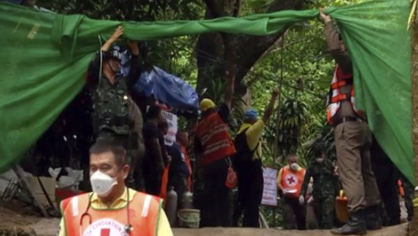 In this grab taken from video provide by Chiang Rai Public Relations Office, emergency workers carry a stretcher with one of the rescued boy to be transported by ambulance to a hospital, in Mae Sai, in the district of Chiang Rai, Thailand. Sunday, July 8, 2018 In this grab taken from video provide by Chiang Rai Public Relations Office, emergency workers carry a stretcher with one of the rescued boy to be transported by ambulance to a hospital, in Mae Sai, in the district of Chiang Rai, Thailand. Sunday, July 8, 2018 - Sputnik International