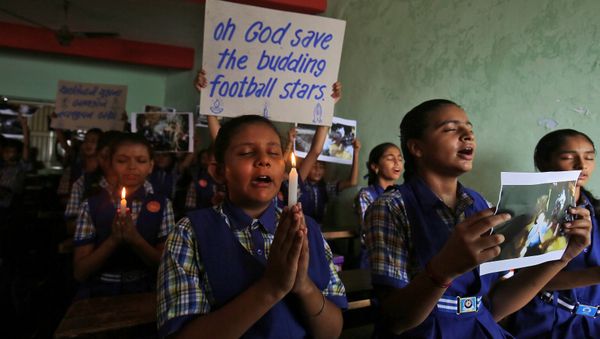 Schoolchildren pray for the schoolboys who are trapped inside a flooded cave in Thailand's northern province of Chiang Rai, at a school in Ahmedabad, India, July 9, 2018. Schoolchildren pray for the schoolboys who are trapped inside a flooded cave in Thailand's northern province of Chiang Rai, at a school in Ahmedabad, India, July 9, 2018. - Sputnik International