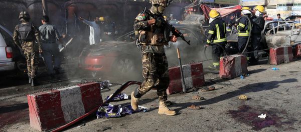 Afghan security forces inspect the site of a blast in Jalalabad city, Afghanistan, July 1, 2018 - Sputnik International