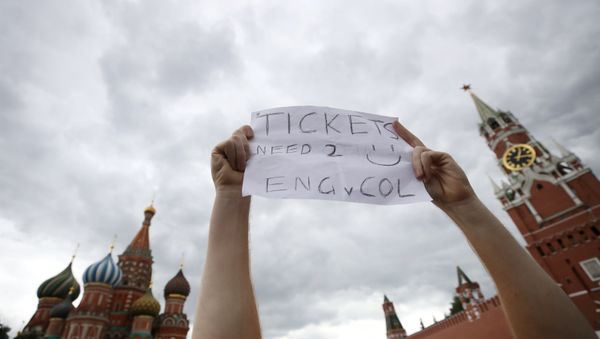 Soccer Football - World Cup - Round of 16 - Colombia vs England - Spartak Stadium, Moscow, Russia - July 3, 2018 England fan holds up a sign asking for tickets before the match in Red Square Soccer Football - World Cup - Round of 16 - Colombia vs England - Spartak Stadium, Moscow, Russia - July 3, 2018 England fan holds up a sign asking for tickets before the match in Red Square - Sputnik International