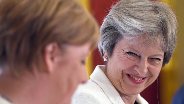 Britain's Prime Minister Theresa May, and Germany's Chancellor Angela Merkel hold a news conference with Polish Prime Minister, Mateusz Morawiecki (unseen) during the Western Balkans Summit 2018 at Lancaster House in London, Britain, July 10, 2018 - Sputnik International