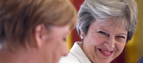 Britain's Prime Minister Theresa May, and Germany's Chancellor Angela Merkel hold a news conference with Polish Prime Minister, Mateusz Morawiecki (unseen) during the Western Balkans Summit 2018 at Lancaster House in London, Britain, July 10, 2018 - Sputnik International
