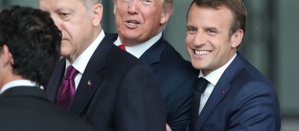 France's President Emmanuel Macron (R) jokes with US President Donald Trump (C) next to Turkey’s President Recep Tayyip Erdogan as they arrive for the NATO (North Atlantic Treaty Organization) summit, at the NATO headquarters in Brussels, on July 11, 2018. - Sputnik International