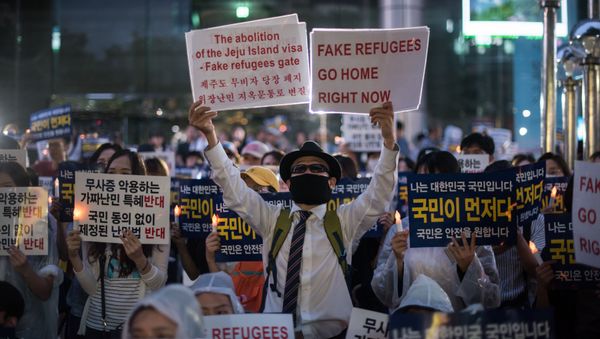 Anti-immigration activists attend a protest against a group of asylum-seekers from Yemen, in Seoul on June 30, 2018 Anti-immigration activists attend a protest against a group of asylum-seekers from Yemen, in Seoul on June 30, 2018 - Sputnik International