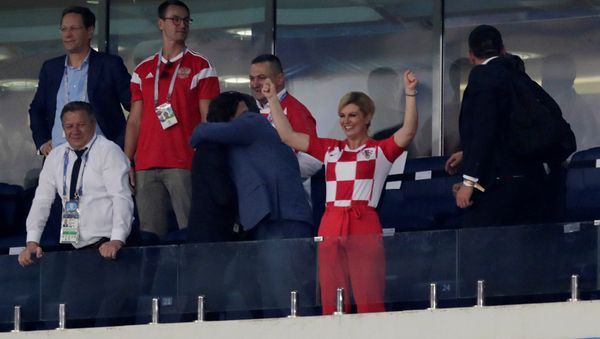 Soccer Football - World Cup - Quarter Final - Russia vs Croatia - Fisht Stadium, Sochi, Russia - July 7, 2018 Croatia president Kolinda Grabar-Kitarovic celebrates in the stand after winning the penalty shootout - Sputnik International