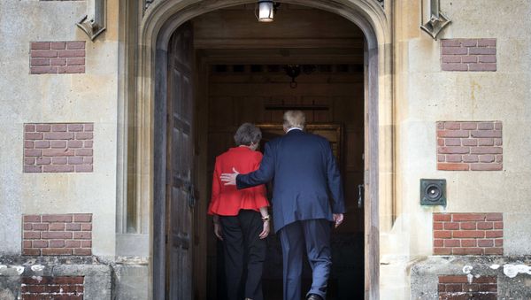 British Prime Minister Theresa May greets U.S President Donald Trump before their meeting at Chequers, in Buckinghamshire, England, Friday, July 13, 2018. - Sputnik International