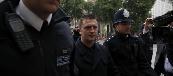 Tommy Robinson the former leader of the far-right EDL English Defence League group is flanked by police officers as he arrives for an appearance at Westminster Magistrates Court in London, Wednesday, Oct. 16, 2013 - Sputnik International