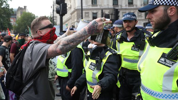 Supporters of English Defence League founder Tommy Robinson are confronted by police officers as they demonstrate in London, Britain July 14, 2018. Supporters of English Defence League founder Tommy Robinson are confronted by police officers as they demonstrate in London, Britain July 14, 2018. - Sputnik International