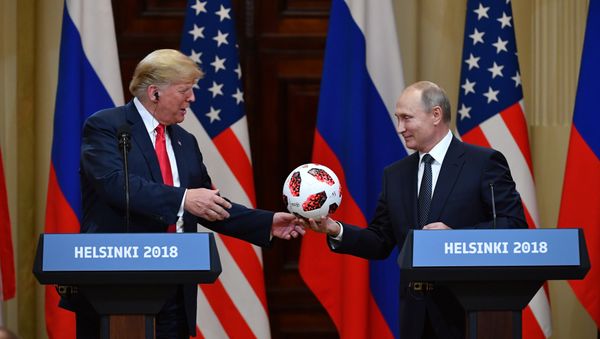 Russia's President Vladimir Putin (R) offers a ball of the 2018 football World Cup to US President Donald Trump during a joint press conference after a meeting at the Presidential Palace in Helsinki, on July 16, 2018 Russia's President Vladimir Putin (R) offers a ball of the 2018 football World Cup to US President Donald Trump during a joint press conference after a meeting at the Presidential Palace in Helsinki, on July 16, 2018 - Sputnik International