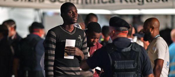 A migrant is pictured after disembarking from the Italian Coast Guard vessel Diciotti at the port of Pozzallo, Sicily on June 19, 2018, following a rescue operation of migrants and refugees at sea - Sputnik International