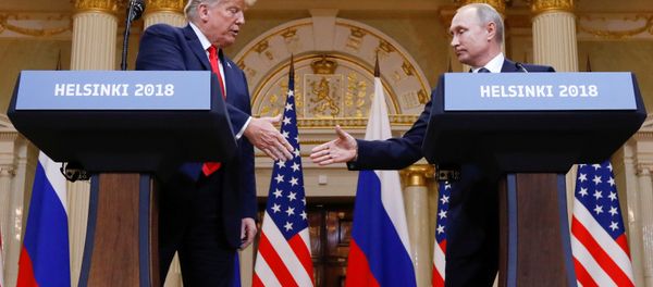U.S. President Donald Trump and Russia's President Vladimir Putin shake hands during a joint news conference after their meeting in Helsinki, Finland, July 16, 2018 - Sputnik International