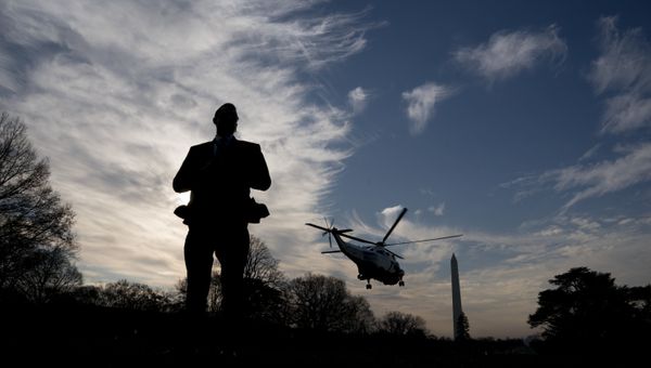 A Secret Service agent stands guard as Marine One with President Donald Trump aboard departs the White House in Washington, Saturday, Dec. 2, 2017, for a short trip to Andrews Air Force Base, Md. where Trump will travel to New York for a fundraising event - Sputnik International