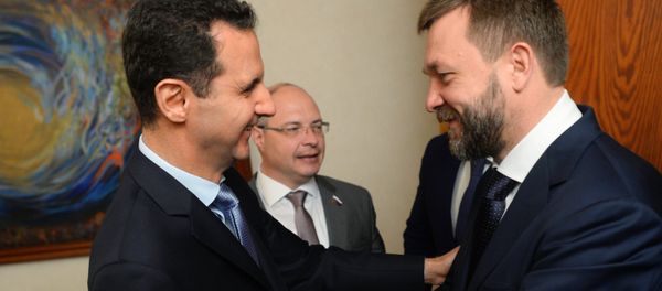 Syrian President Bashar al-Assad, left, meets with the Russian Federation Council Dmitry Sablin in Damascus Syrian President Bashar al-Assad, left, meets with the Russian Federation Council Dmitry Sablin in Damascus - Sputnik International
