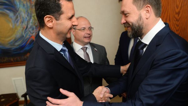Syrian President Bashar al-Assad, left, meets with the Russian Federation Council Dmitry Sablin in Damascus Syrian President Bashar al-Assad, left, meets with the Russian Federation Council Dmitry Sablin in Damascus - Sputnik International