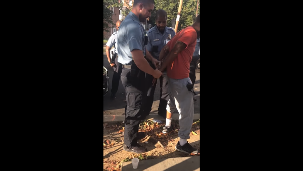 DC police officer Sean Lojacono conducts a stop and frisk on MB Cottingham. - Sputnik International