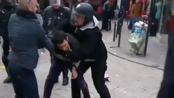 In this image taken from video, a man identified as Alexandre Benalla, right, a security chief to French President Emmanuel Macron, confronting a student during a May Day demonstration in Paris, May 1, 2018 - Sputnik International