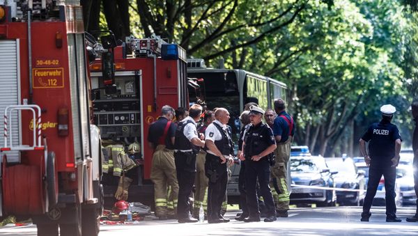 Policemen stand near a public service bus in Kuecknitz near Luebeck northern Germany, after several people were injured in the bus in an assault by a man wielding a knife on July 20, 2018 Policemen stand near a public service bus in Kuecknitz near Luebeck northern Germany, after several people were injured in the bus in an assault by a man wielding a knife on July 20, 2018 - Sputnik International