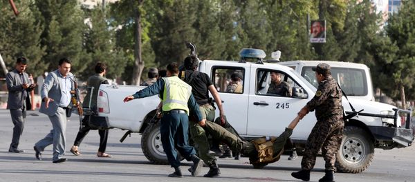 Afghan policemen carry a wounded man at the site of a blast in Kabul, Afghanistan, July 22, 2018 Afghan policemen carry a wounded man at the site of a blast in Kabul, Afghanistan, July 22, 2018 - Sputnik International