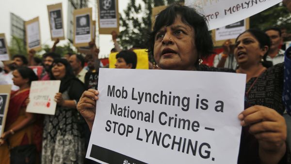 Indians hold placards and shout slogans during a protest against mob attacks in Ahmadabad, India, Monday, July 23, 2018 - Sputnik International