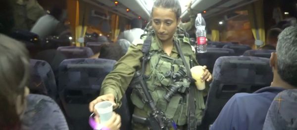 An Israeli solider hands out water on a bus, during the Syria Civil Defence, also known as the White Helmets, extraction from the Golan Heights, Israel in this still image taken from video, provided by the Israeli Army July 22, 2018 An Israeli solider hands out water on a bus, during the Syria Civil Defence, also known as the White Helmets, extraction from the Golan Heights, Israel in this still image taken from video, provided by the Israeli Army July 22, 2018 - Sputnik International