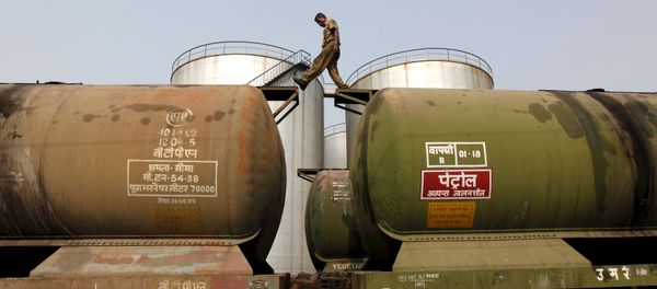 A worker walks atop a tanker wagon to check the freight level at an oil terminal on the outskirts of Kolkata, India November 27, 2013 A worker walks atop a tanker wagon to check the freight level at an oil terminal on the outskirts of Kolkata, India November 27, 2013 - Sputnik International