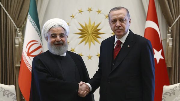 Turkey's President Recep Tayyip Erdogan, right, and Iran's President Hassan Rouhani shake hands before a meeting in Ankara, Turkey, Wednesday, April 4, 2018 - Sputnik International