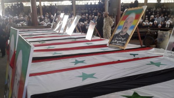 In this photo released by the Syrian official news agency SANA, mourners attend a mass funeral of people killed a day earlier by a series of suicide bombings launched by the Islamic State's fighters on the eastern and northern countryside of the southern province of al-Sweida during a in al-Sweida, Syria, Thursday, July 26, 2018 In this photo released by the Syrian official news agency SANA, mourners attend a mass funeral of people killed a day earlier by a series of suicide bombings launched by the Islamic State's fighters on the eastern and northern countryside of the southern province of al-Sweida during a in al-Sweida, Syria, Thursday, July 26, 2018 - Sputnik International