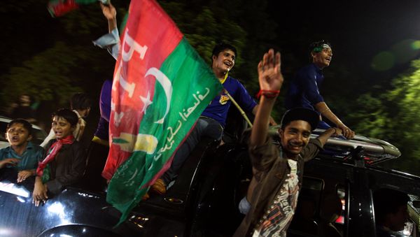 Supporters of Imran Khan, chairman of the Pakistan Tehreek-e-Insaf (PTI), political party celebrate during the general election in Islamabad, Pakistan, July 26, 2018 Supporters of Imran Khan, chairman of the Pakistan Tehreek-e-Insaf (PTI), political party celebrate during the general election in Islamabad, Pakistan, July 26, 2018 - Sputnik International