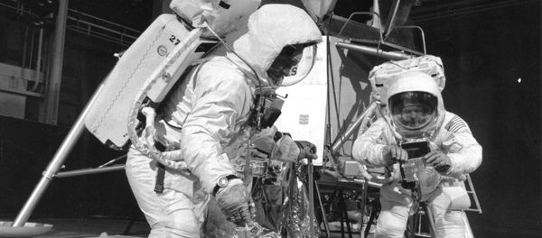 Two members of the Apollo 11 lunar landing mission participate in a simulation of deploying and using lunar tools on the surface of the Moon during a training exercise on April 22, 1969 - Sputnik International