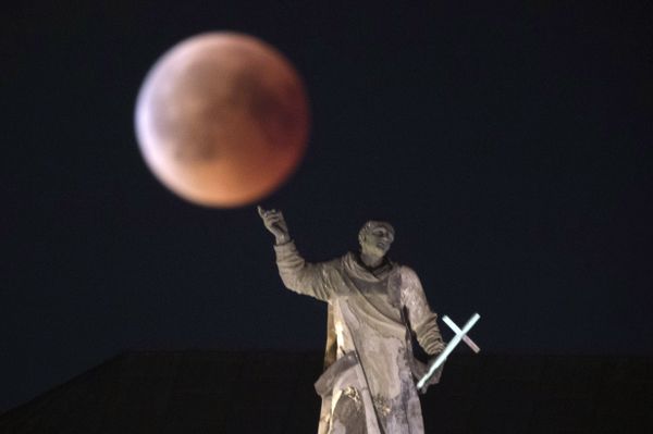 The moon turns red during a total lunar eclipse, as seen from Dresden, Germany, Friday, July 27, 2018. Skywatchers around much of the world are looking forward to a complete lunar eclipse that will be the longest this century.  - Sputnik International