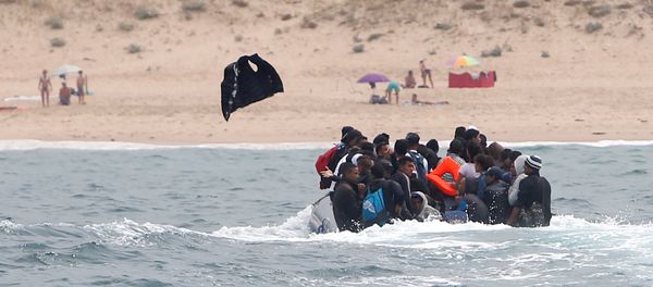 Migrants throws up a life-vest before disembarking from a dinghy at Del Canuelo beach after they crossed the Strait of Gibraltar sailing from the coast of Morocco, in Tarifa, southern Spain, July 27, 2018 Migrants throws up a life-vest before disembarking from a dinghy at Del Canuelo beach after they crossed the Strait of Gibraltar sailing from the coast of Morocco, in Tarifa, southern Spain, July 27, 2018 - Sputnik International