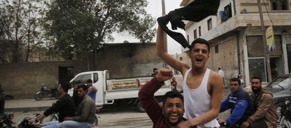 In this photo taken on Wednesday, March 28, 2018, Syrian soccer fans celebrate after their local team won a game, in Manbij, north Syria. Manbij, a mixed Arab and Kurdish town of nearly 400,000, was liberated from Islamic State militants in 2016 by the YPG fighters with backing from U.S-led coalition airstrikes. With Turkey's threats, the town has become the axle for U.S. policy in Syria, threatening its prestige and military deployment in eastern Syria In this photo taken on Wednesday, March 28, 2018, Syrian soccer fans celebrate after their local team won a game, in Manbij, north Syria. Manbij, a mixed Arab and Kurdish town of nearly 400,000, was liberated from Islamic State militants in 2016 by the YPG fighters with backing from U.S-led coalition airstrikes. With Turkey's threats, the town has become the axle for U.S. policy in Syria, threatening its prestige and military deployment in eastern Syria - Sputnik International