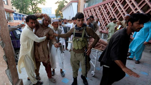 Men carry an injured man in a hospital after a suicide attack in Jalalabad, Afghanistan July 30, 2018 Men carry an injured man in a hospital after a suicide attack in Jalalabad, Afghanistan July 30, 2018 - Sputnik International