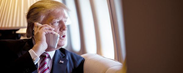 President Donald Trump talks on the phone aboard Air Force One during a flight to Philadelphia, Pennsylvania, to address a joint gathering of House and Senate Republicans, Thursday, January 26, 2017 (File photo). - Sputnik International