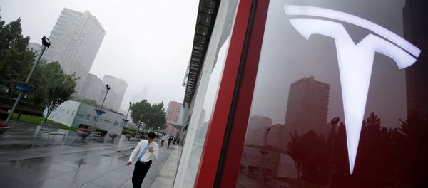 A man walks near a logo of Tesla outside its China headquarters at China Central Mall in Beijing, China July 11, 2018 A man walks near a logo of Tesla outside its China headquarters at China Central Mall in Beijing, China July 11, 2018 - Sputnik International