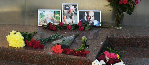 Flowers brought at the photos of three Russian journalists killed in the Central African Republic, from right: Orkhan Dzhemal, Kirill Radchenko and Alexander Rastorguyev, near the Central House of Journalists in Moscow. File photo Flowers brought at the photos of three Russian journalists killed in the Central African Republic, from right: Orkhan Dzhemal, Kirill Radchenko and Alexander Rastorguyev, near the Central House of Journalists in Moscow. File photo - Sputnik International