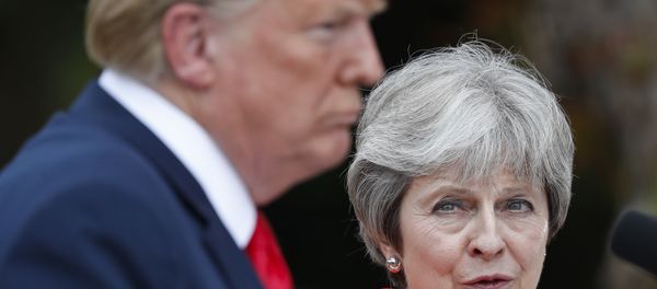 British Prime Minister Theresa May, right, looks over to President Donald Trump, left, during their joint news conference at Chequers, in Buckinghamshire, England, Friday, July 13, 2018 - Sputnik International