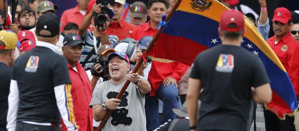 Argentina's former soccer star Diego Armando Maradona waves a Venezuelan flag during the closing campaign rally of President Nicolas Maduro in Caracas, Venezuela, Thursday, May 17, 2018. Maduro is seeking a new six-year mandate and despite crippling hyperinflation and widespread shortages of food and medicine, he is widely expected to win it in next May 20 election, that opponents have denounced as a fraud and have been condemned by much of the international community Argentina's former soccer star Diego Armando Maradona waves a Venezuelan flag during the closing campaign rally of President Nicolas Maduro in Caracas, Venezuela, Thursday, May 17, 2018. Maduro is seeking a new six-year mandate and despite crippling hyperinflation and widespread shortages of food and medicine, he is widely expected to win it in next May 20 election, that opponents have denounced as a fraud and have been condemned by much of the international community - Sputnik International