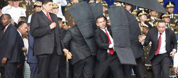 Security personnel surround Venezuela's President Nicolas Maduro Security personnel surround Venezuela's President Nicolas Maduro - Sputnik International