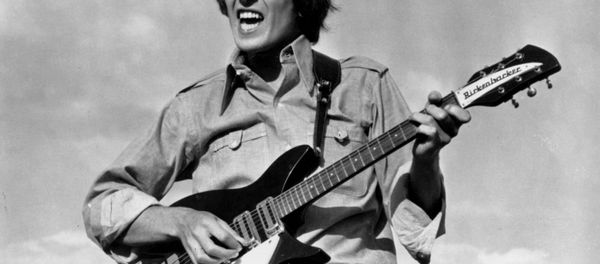 Beatle George Harrison is shown playing the guitar in a scene from the Beatles movie Help! on location in the Bahamas in 1965. Beatle George Harrison is shown playing the guitar in a scene from the Beatles movie Help! on location in the Bahamas in 1965. - Sputnik International