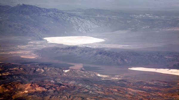 Groom Lake and Papoose Lake, both in the Nevada Test and Training Range. Groom Lake is also in Area 51. Note that some of the lines you see beside Groom lake are among the longest runways on Earth. - Sputnik International