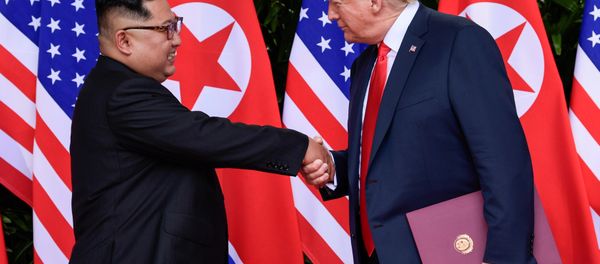 U.S. President Donald Trump and North Korea's leader Kim Jong Un shake hands during the signing of a document after their summit at the Capella Hotel on Sentosa island in Singapore June 12, 2018 U.S. President Donald Trump and North Korea's leader Kim Jong Un shake hands during the signing of a document after their summit at the Capella Hotel on Sentosa island in Singapore June 12, 2018 - Sputnik International