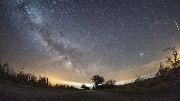 The milky way and traces of meteors illuminate the sky over Burg on the Baltic Sea island of Fehmarn, northern Germany, Friday, April 20, 2018 when the Lyrids meteor shower went down The milky way and traces of meteors illuminate the sky over Burg on the Baltic Sea island of Fehmarn, northern Germany, Friday, April 20, 2018 when the Lyrids meteor shower went down - Sputnik International