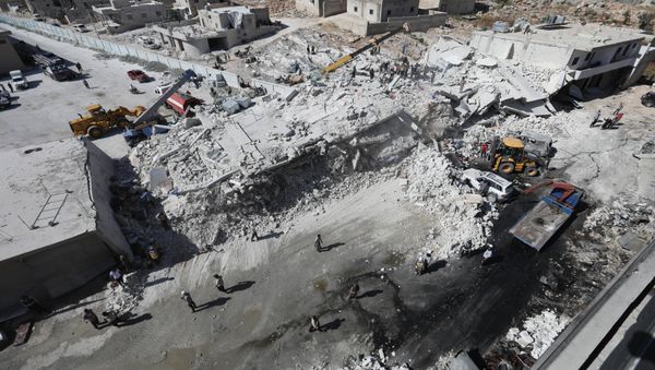 Destroyed buildings are seen on August 12, 2018 following an explosion at an arms depot in a residential area in Syria's northern Idlib province city of Sarmada in which 12 people were reportedly killed. - Sputnik International