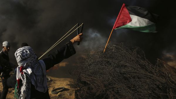 A female protester hurls a stone while others burn tires near the fence of the Gaza Strip border with Israel, during a protest east of Khan Younis, southern Gaza Strip, Friday, Aug. 10, 2018. Violence erupted at the Gaza border Friday after the territory's militant Islamic Hamas rulers and Israel appeared to be honoring a cease-fire that ended two days of intense violence amid efforts by neighboring Egypt to negotiate between the two sides - Sputnik International