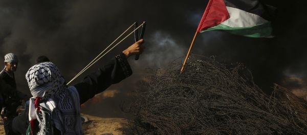 A female protester hurls a stone while others burn tires near the fence of the Gaza Strip border with Israel, during a protest east of Khan Younis, southern Gaza Strip, Friday, Aug. 10, 2018. Violence erupted at the Gaza border Friday after the territory's militant Islamic Hamas rulers and Israel appeared to be honoring a cease-fire that ended two days of intense violence amid efforts by neighboring Egypt to negotiate between the two sides A female protester hurls a stone while others burn tires near the fence of the Gaza Strip border with Israel, during a protest east of Khan Younis, southern Gaza Strip, Friday, Aug. 10, 2018. Violence erupted at the Gaza border Friday after the territory's militant Islamic Hamas rulers and Israel appeared to be honoring a cease-fire that ended two days of intense violence amid efforts by neighboring Egypt to negotiate between the two sides - Sputnik International