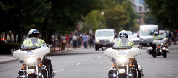 Police on motorcycles are pictured near a protest against the white nationalist-led Unite the Right rally held in front of the White House on the one-year anniversary of the white nationalist-led rally in Charlottesville, VA, in downtown Washington, U.S., August 12, 2018. - Sputnik International