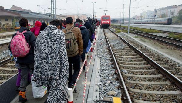 Migrants walk on a platform of the railway station in Passau, southern Germany, to a special train to bring them to Duesseldof, western Germany, on November 3, 2015 - Sputnik International